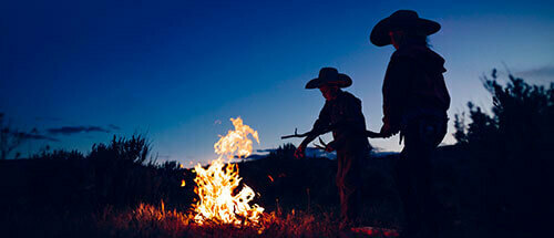 Kids feeding a fire